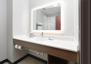 A modern bathroom with a white sink, a mirror, and a towel rack. - Holiday Inn Express & Suites Denton North by IHG (Denton)