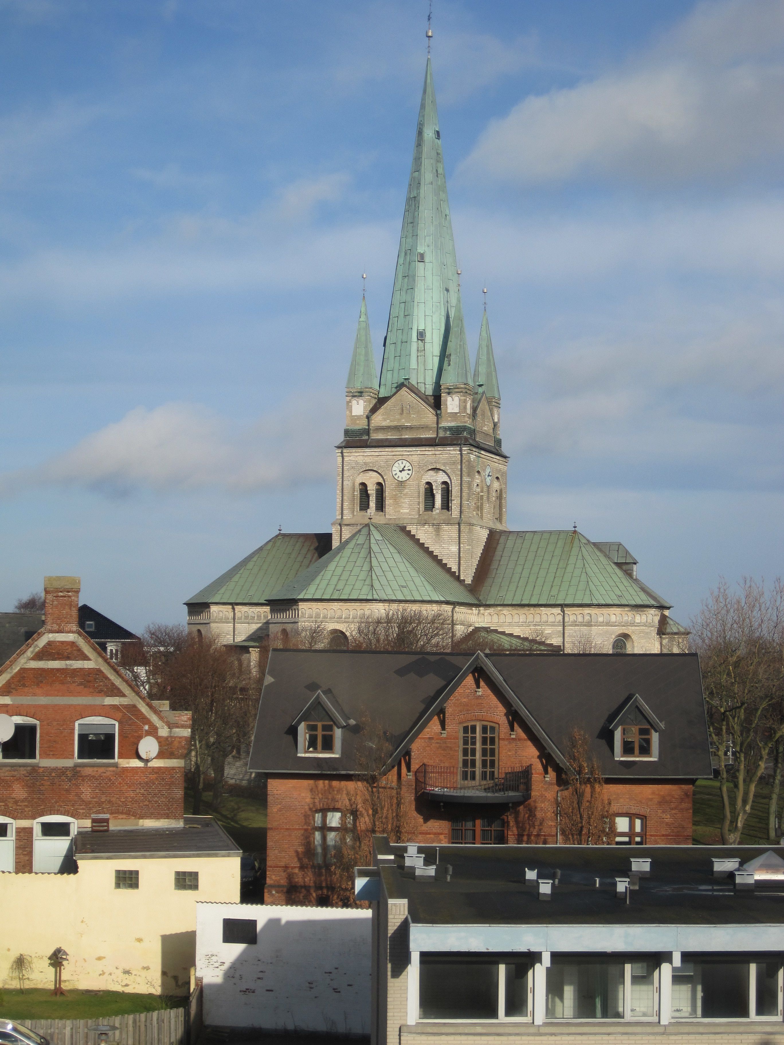 A church with a tall spire and a clock tower.