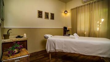 Relax in a serene room with a neatly made bed, bedside table, and wall-mounted air conditioning unit.