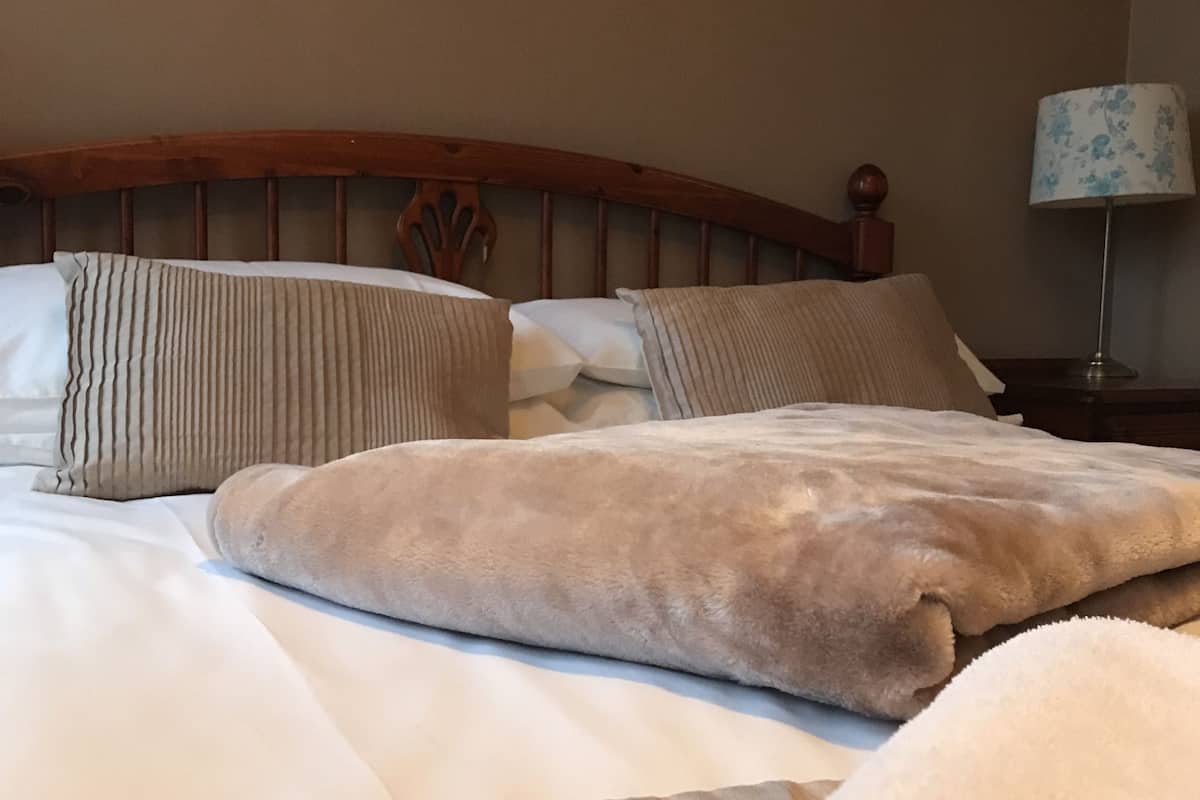 Premium bedding, desk, laptop workspace, blackout drapes