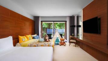 A hotel room with a large bed, a desk, a TV, and a view of the outdoors.
