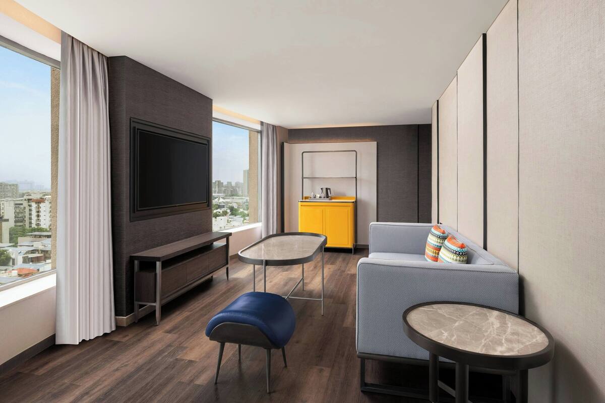 signature suite, 1 king bed, non smoking, city view | living room | 55-inch flat-screen tv with satellite channels, tv, ipod dock