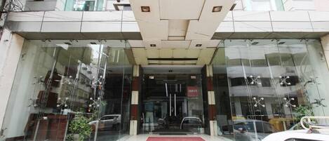 A building with a large glass entrance and a sign reading "AURA".