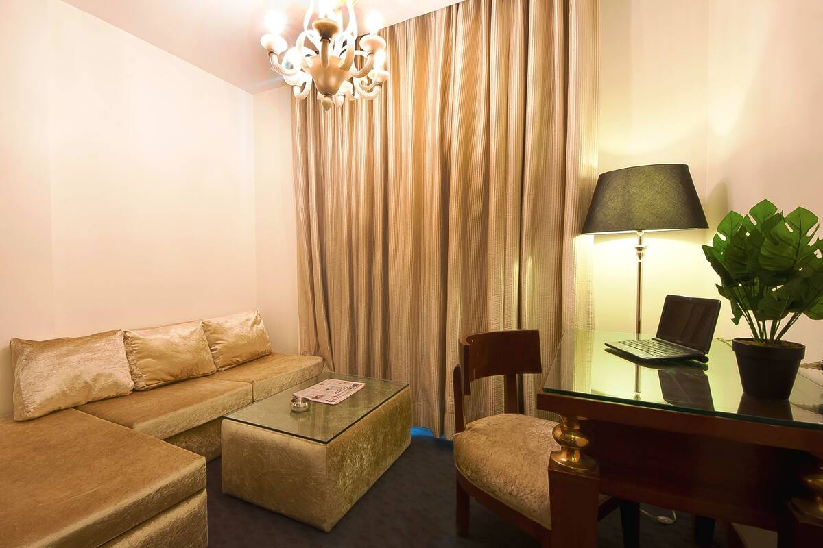 Aura Suite Room | Minibar, in-room safe, desk, iron/ironing board