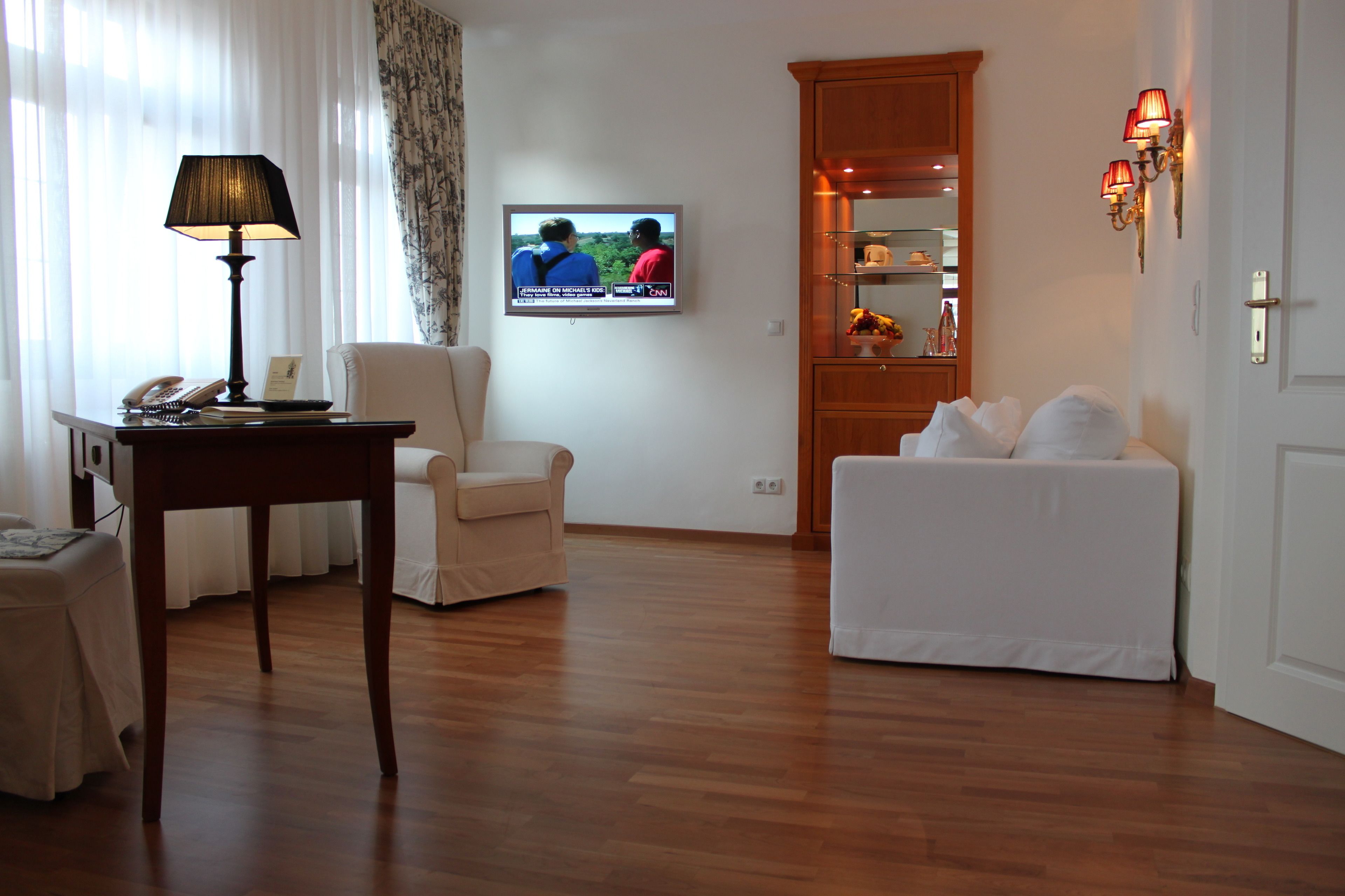 panoramic suite, city view, tower | living area | led tv