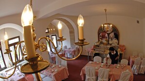 A banquet hall with tables set for a formal event, featuring chandeliers and a central decorative mirror. - Hotel Deutscher Kaiser (Nuremberg)