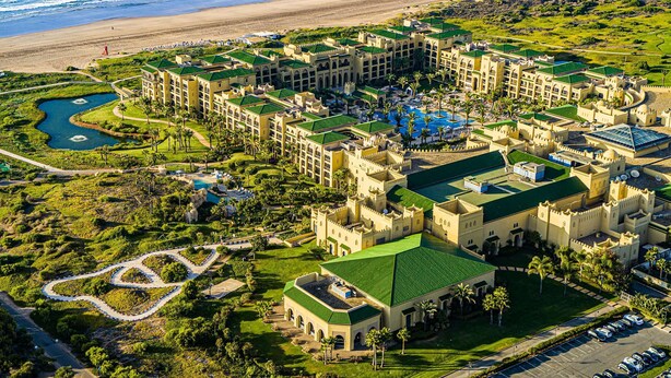 A resort with multiple buildings, a swimming pool, and a golf course. - Mazagan Beach & Golf Resort (El Jadida)
