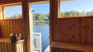 Una cabaña de madera con vista a un lago y un muelle.