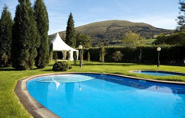 Indoor pool, seasonal outdoor pool, pool umbrellas, pool loungers