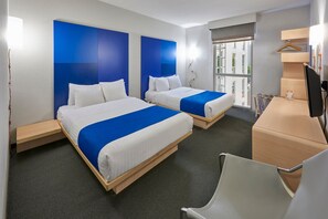 A hotel room with two beds, a desk, a chair, and a window with a view of buildings. - City Express Plus by Marriott Ciudad de México Reforma El Ángel (Mexico City)