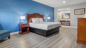 Une chambre à coucher comprenant un lit, des tables de chevet, une commode et une chaise.