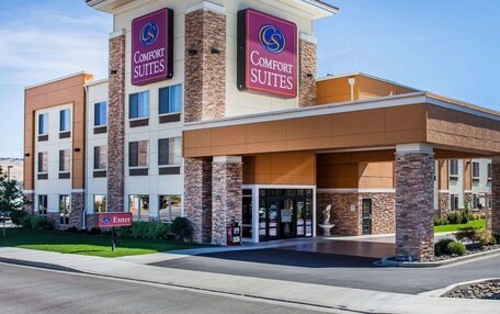 A Comfort Suites hotel with a modern design, featuring a prominent entrance and signage.