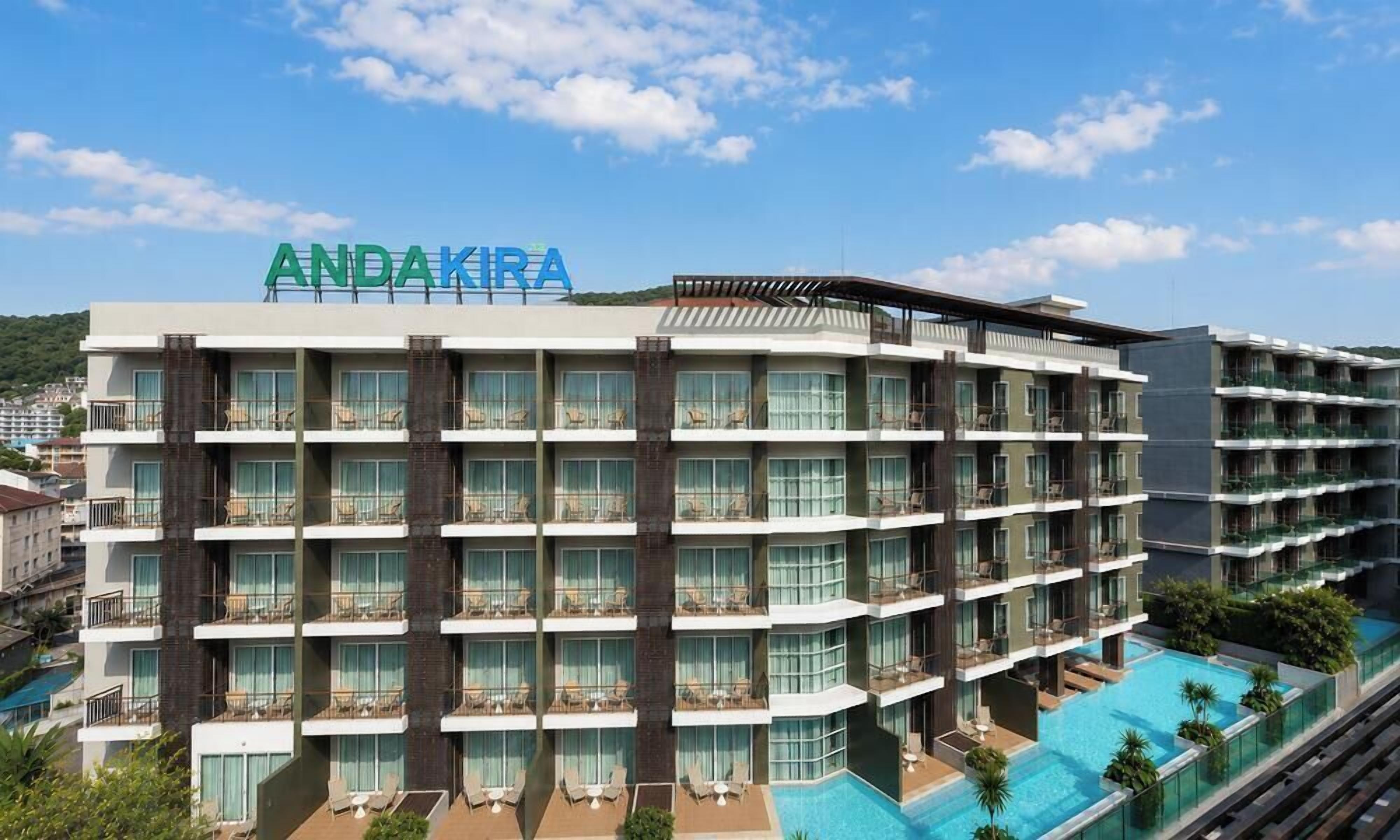 A multi-story hotel with balconies and a swimming pool.