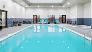 A swimming pool with lounge chairs and a changing room. - TownePlace Suites by Marriott Farmington (Farmington)