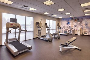 Stay active with our fully equipped fitness center featuring treadmills, ellipticals, and a bench for a variety of exercises.