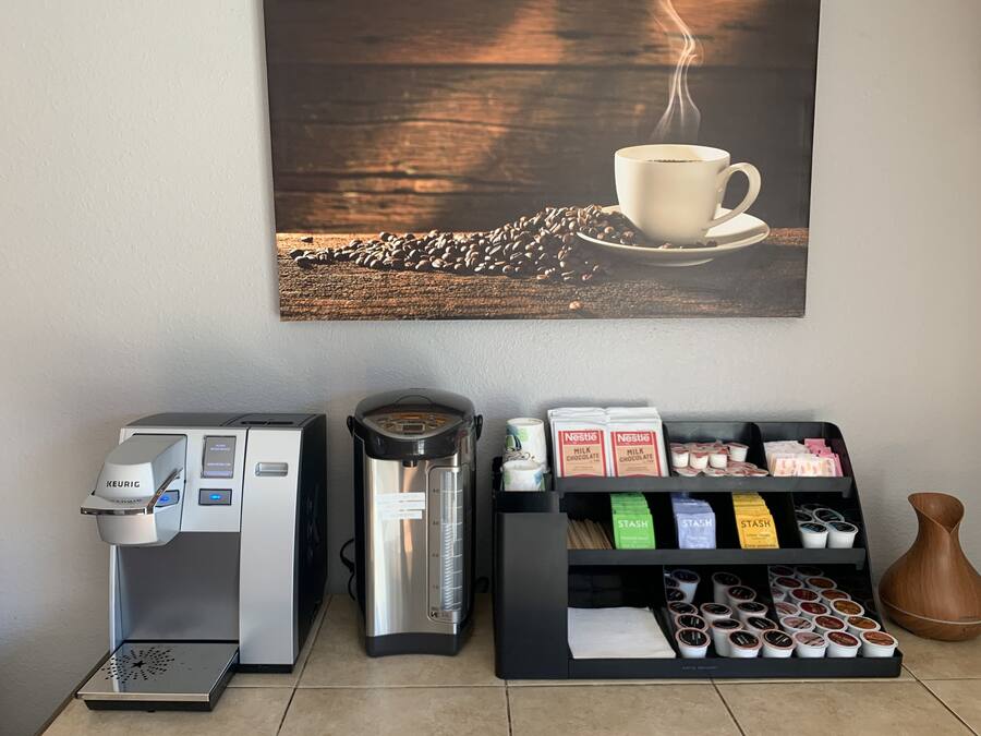 A coffee machine, a coffee press, and a coffee bean dispenser.
