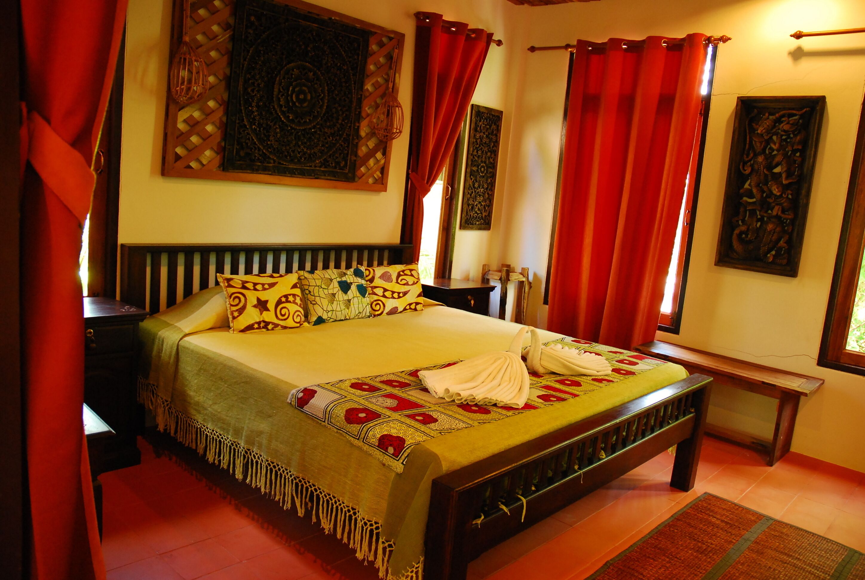 A neatly arranged bedroom with a bed, a bedside table, and a bench.