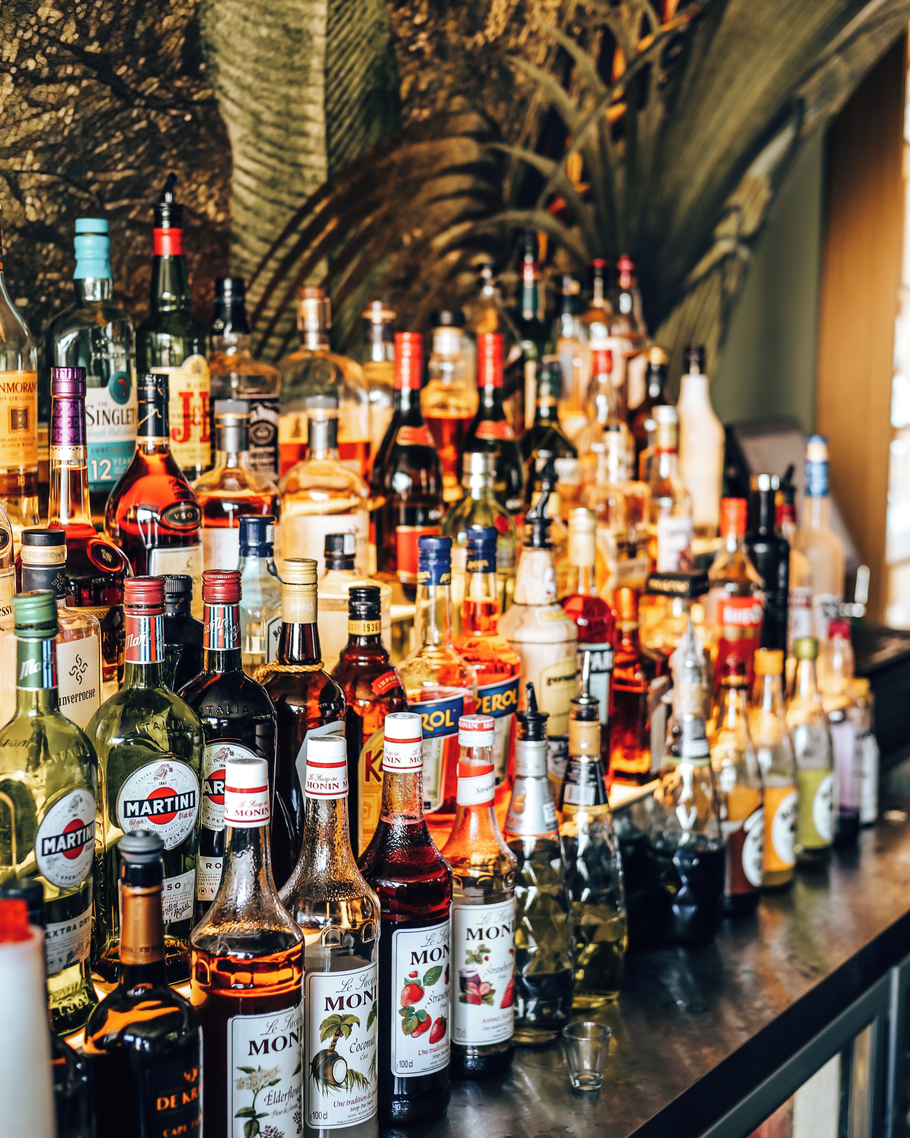 A bar with a variety of liquor bottles on display.