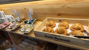 A bakery display with croissants and various packaged goods. - Hotel Europa (Seville)
