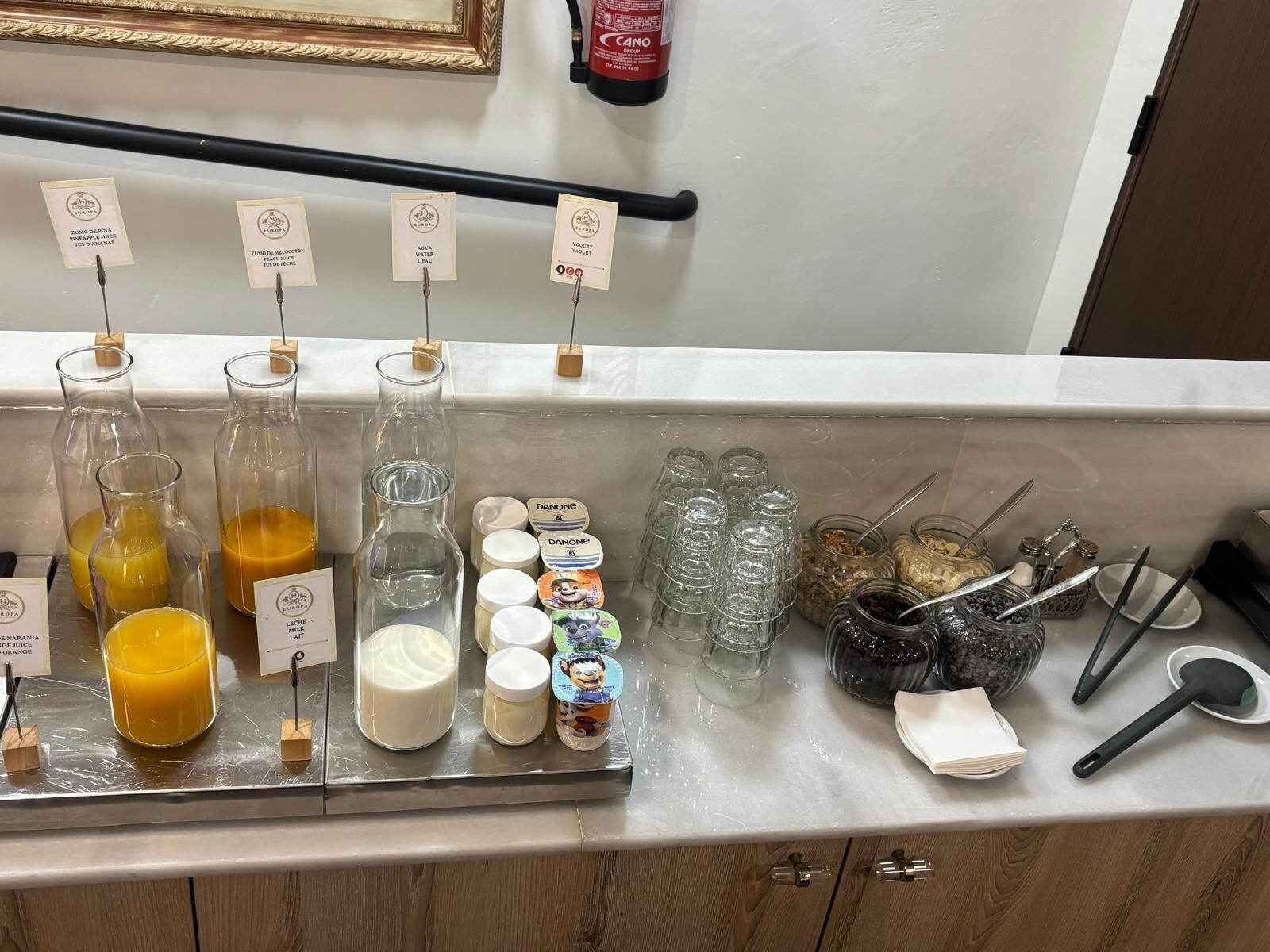A beverage station with various drinks and condiments.