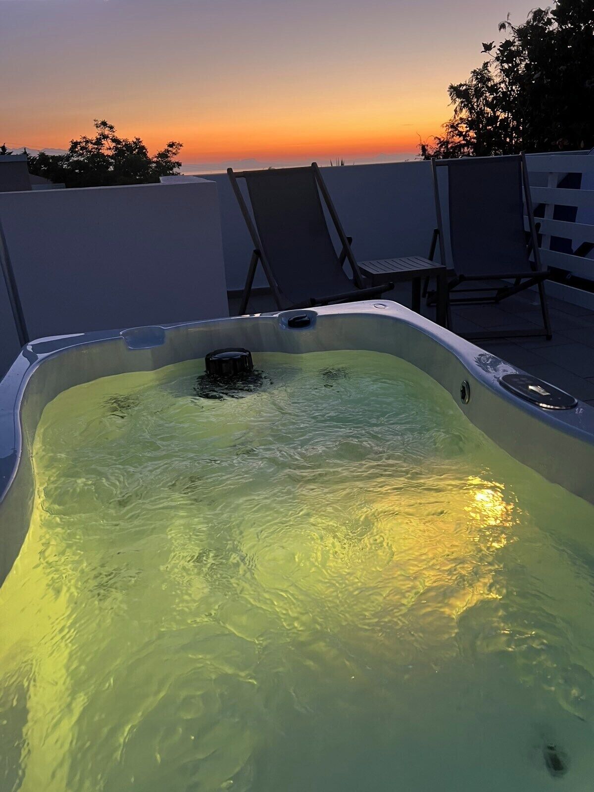 A hot tub with a view of the sunset.
