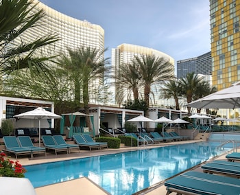 A cityscape with prominent buildings including the Aria, a large hotel with a lit sign, and the Dolce & Gabbana store. at Waldorf Astoria Las Vegas