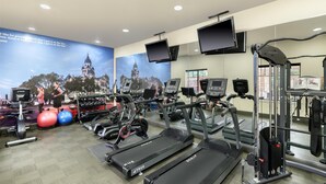 A gym with treadmills, exercise balls, and weight machines. - Best Western Premier Crown Chase Inn & Suites (Denton)