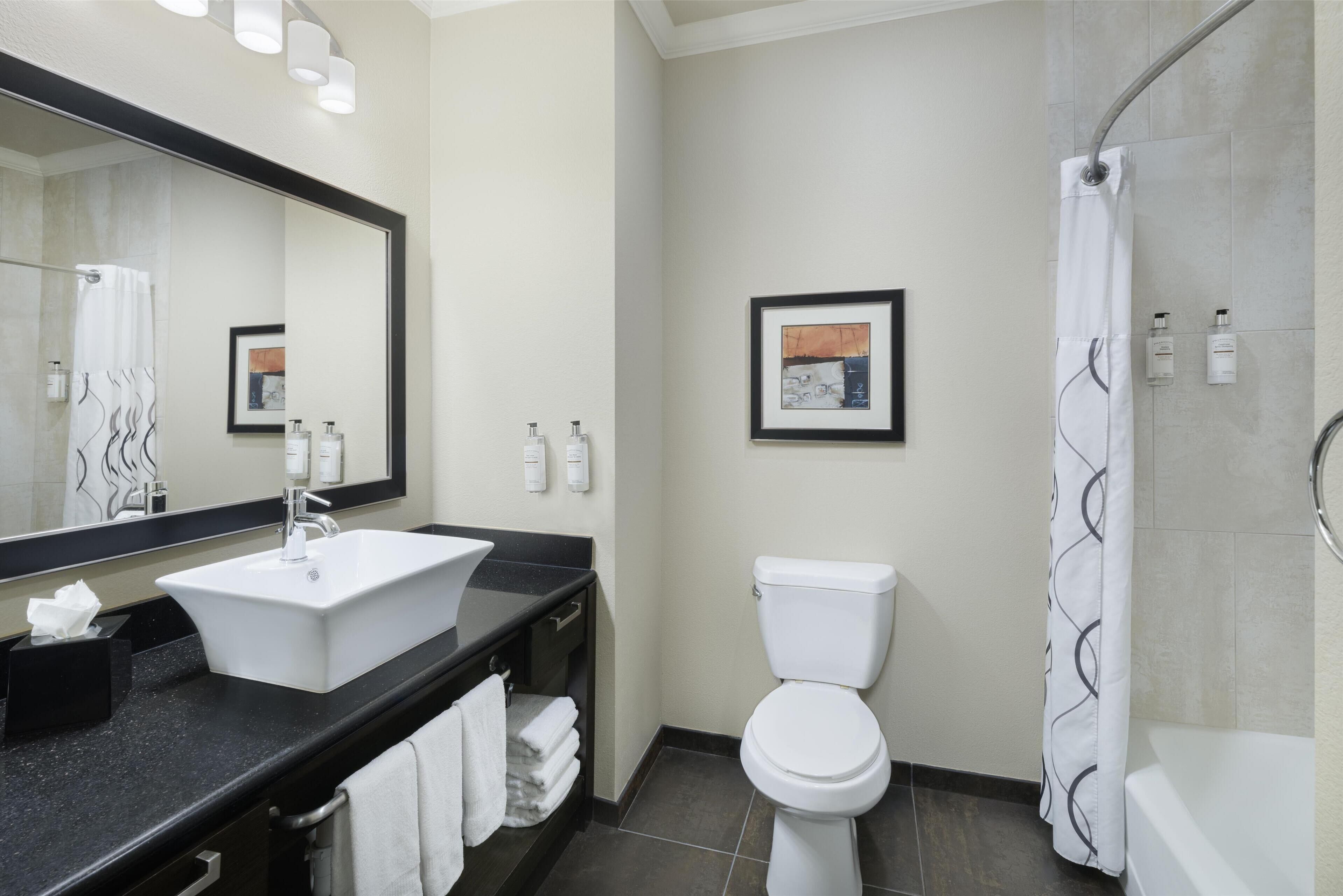 deluxe room, 2 queen beds, non smoking, refrigerator & microwave (oversized room) | bathroom | shower, designer toiletries, hair dryer, towels