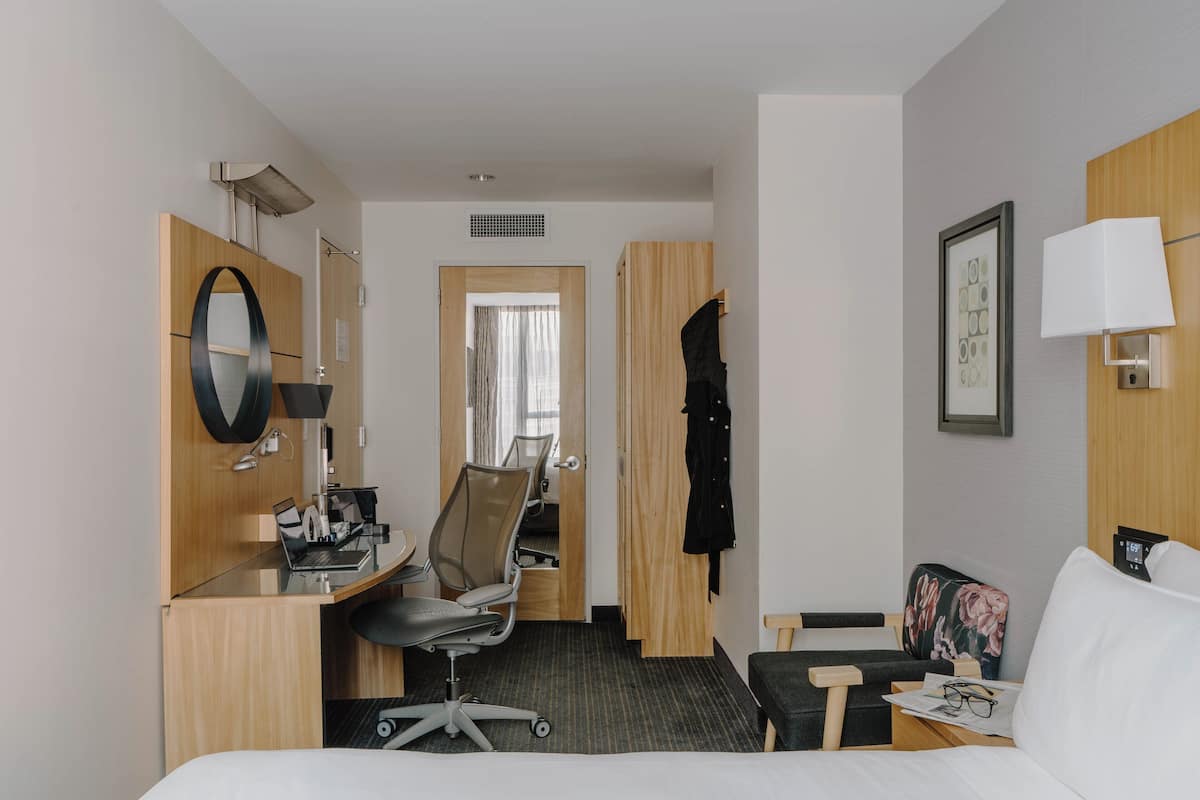 Relax in a spacious room with a large bed, desk, and seating area.