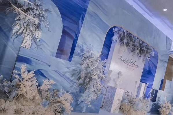 A decorative wall with a winter theme, including snow-like decorations and a sign with a signature. - The Center Hotel (Yantai)