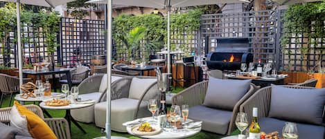 An outdoor dining area with tables, chairs, and umbrellas.
