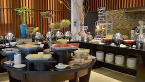 A buffet with various food items and a sign indicating soup, noodle, boiled rice, and coffee. - Signature Pattaya Hotel (Pattaya)