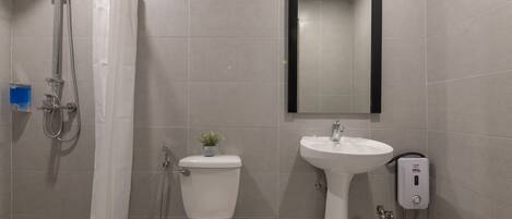 A modern bathroom with a shower, toilet, and sink.