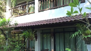A two-story building with a tiled roof, large windows, and a balcony. - Villa Molek (Langkawi)