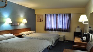 A hotel room with two beds, a desk with a chair, a coffee maker, and a TV. - Canadas Best Value Inn Mile 0 (Lillooet)