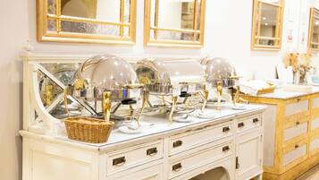 A white vanity with gold accents, a mirror, and a basket.