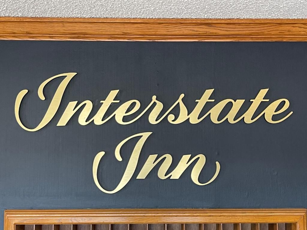 A sign with the text 'Interstate Inn' in a stylized font.