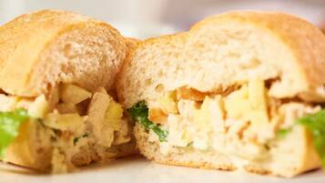 A sandwich cut in half, revealing its contents.