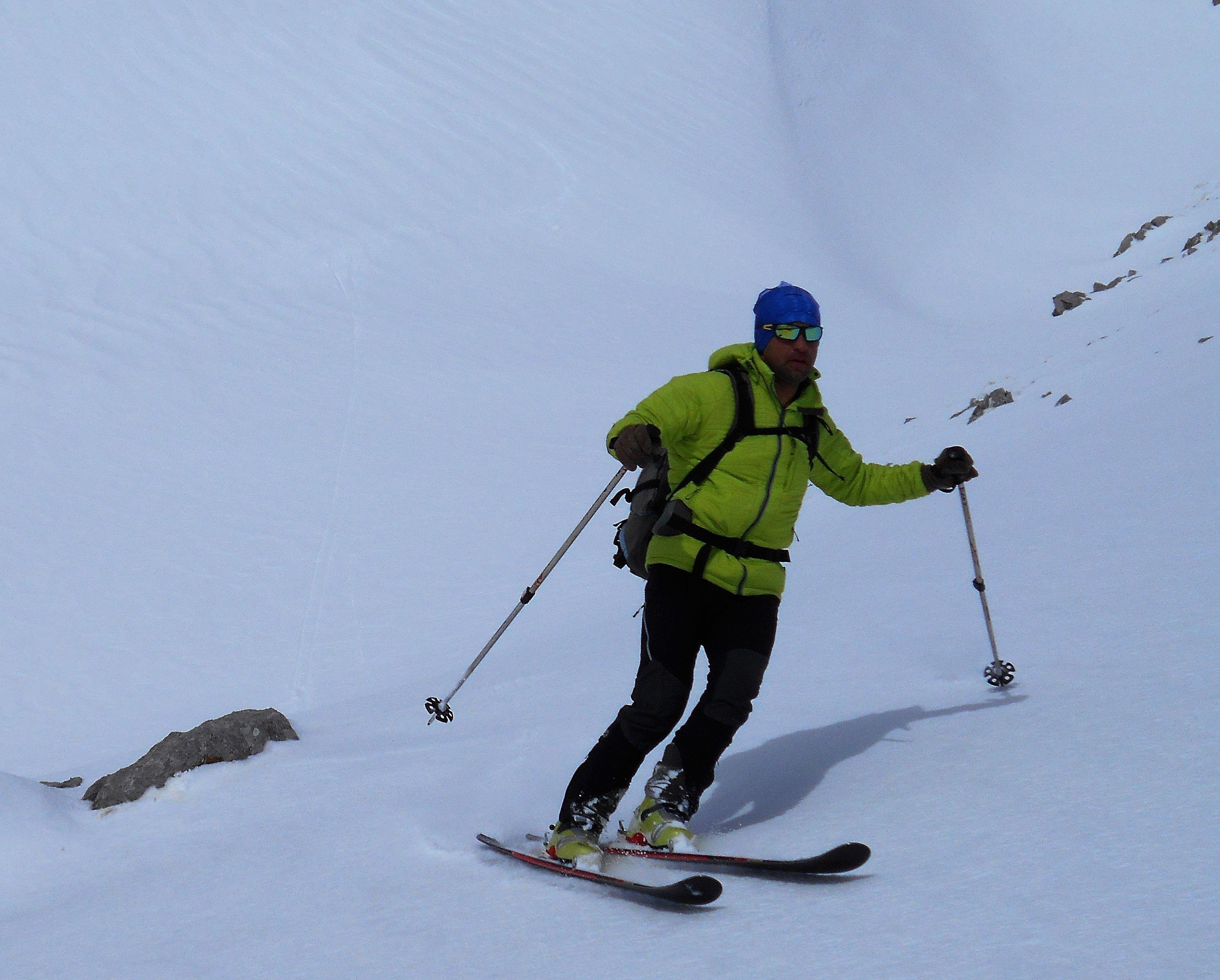 A person skiing down a snowy slope.