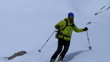 A person skiing down a snowy slope.