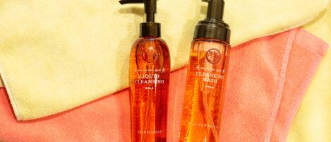 Two bottles of liquid cleansing and cleansing wash on a towel.