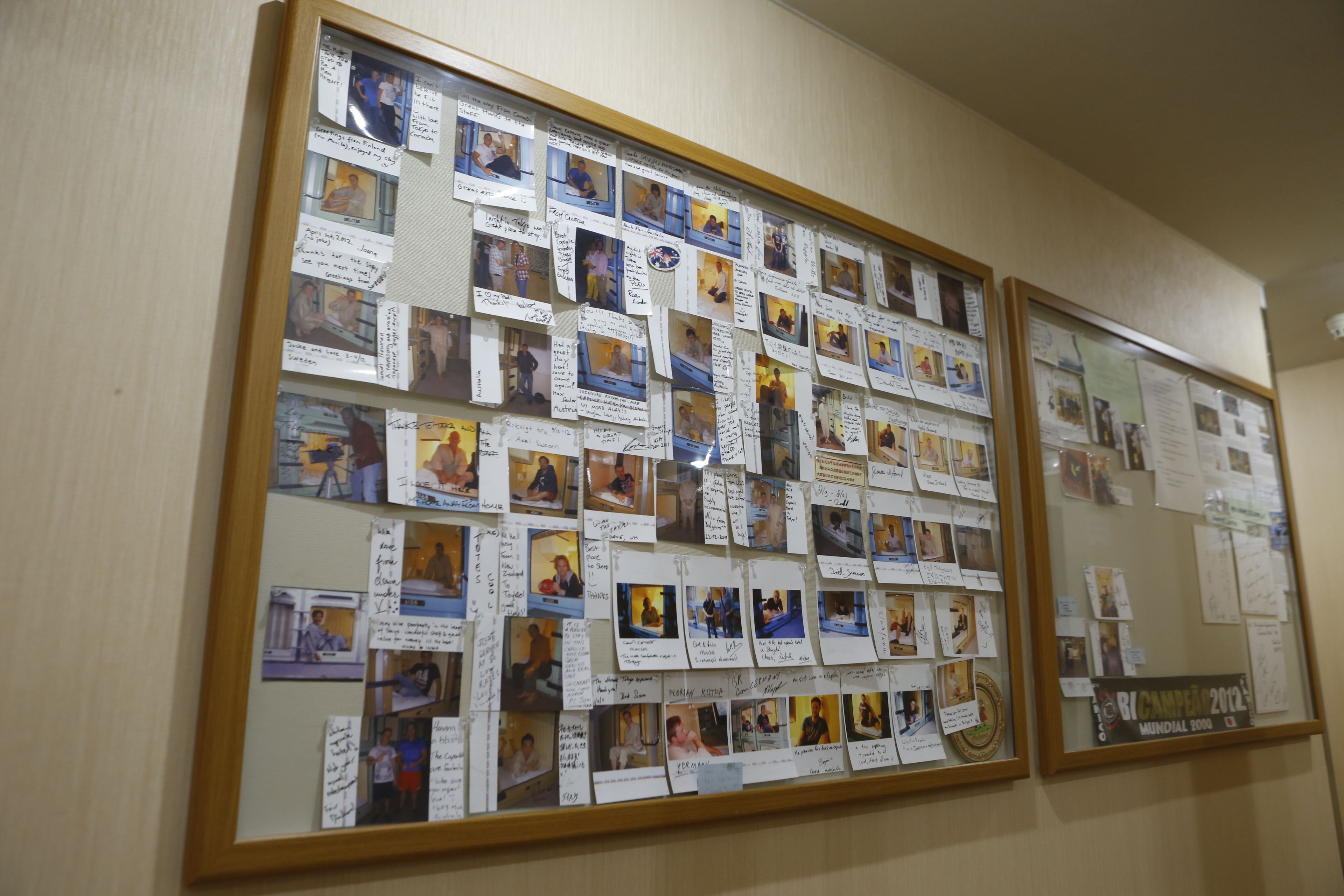 A bulletin board with photos and notes pinned to it.