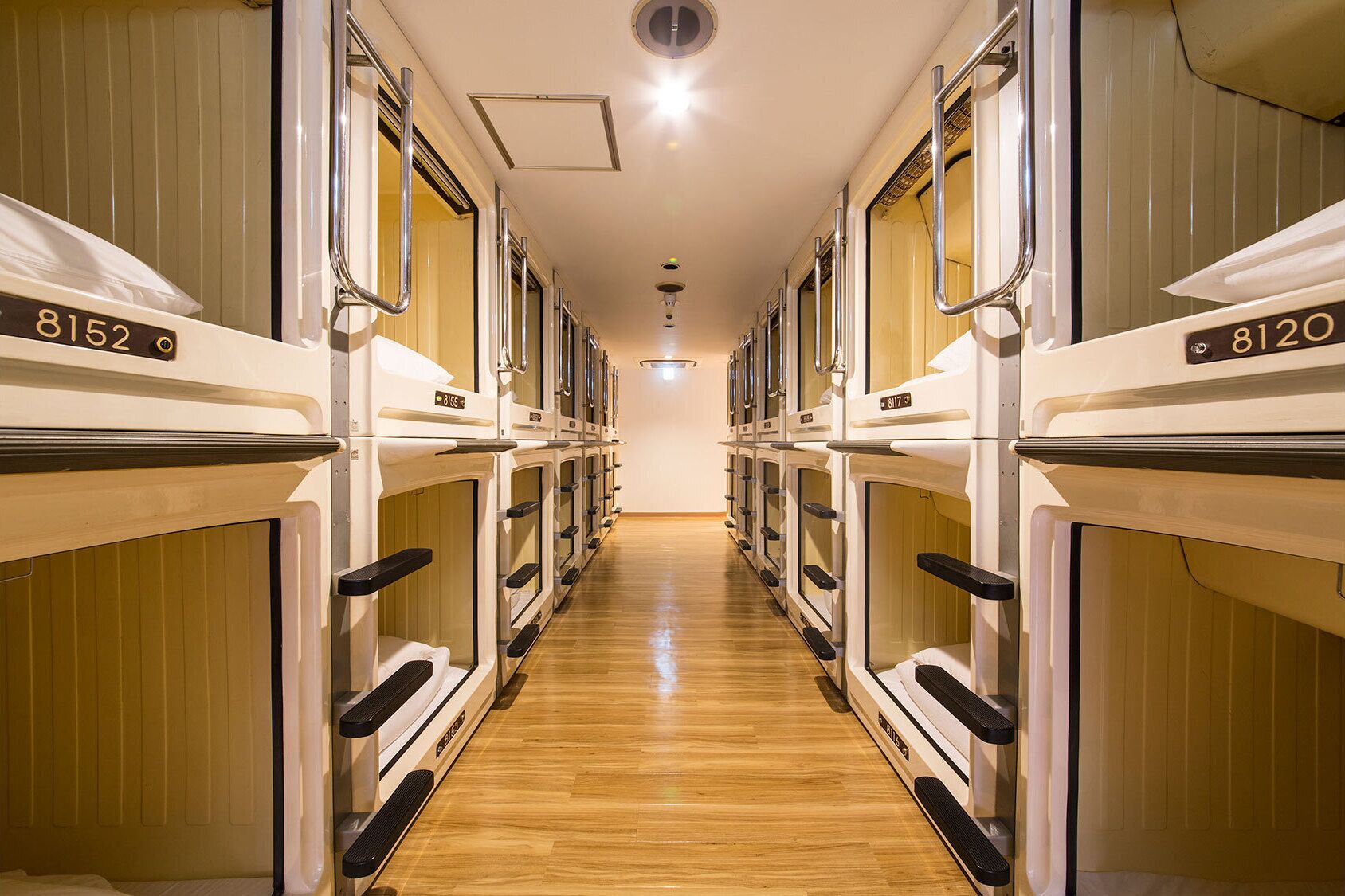 A corridor with bunk beds, each marked with a number.