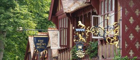 A traditional building with a sign reading "Five Arrows Hotel."