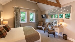 A bedroom with a bed, a desk, a chair, and a television. - The Five Arrows Hotel (Aylesbury)
