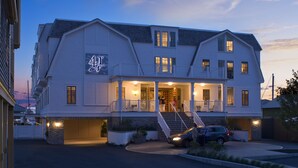 A large, two-story building with a prominent '41' sign, multiple balconies, and a well-lit entrance. - Forty 1 North (Newport)