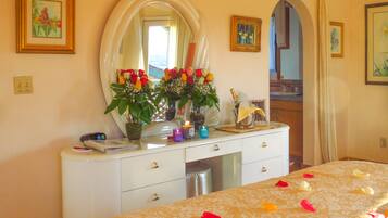 Relax in a beautifully appointed room with a large mirror, dresser, and comfortable bed.