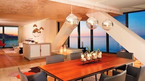 A modern dining area with a wooden table, grey chairs, and hanging spherical light fixtures. - Le Méridien Oran Hotel & Convention Centre (Oran)