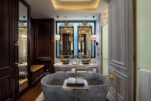 Separate tub and shower, designer toiletries, hair dryer, bathrobes