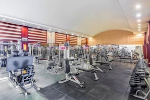 A gym with various exercise equipment, including weight machines and free weights. - Enraton International Hotel (Xining)